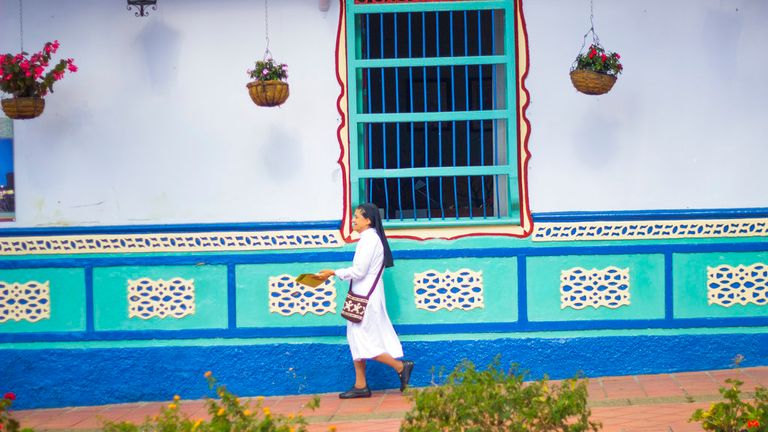 People walking in a sunny day in Guatape. Pic: AP