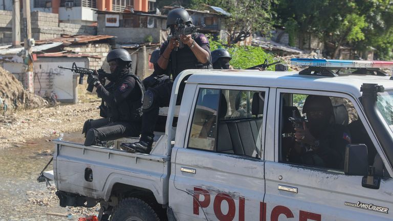 Police officers patrol the area during an exchange of gunfire between gangs and police in Port-au-Prince, Haiti, Monday, Nov. 11, 2024. (AP Photo/Odelyn Joseph)