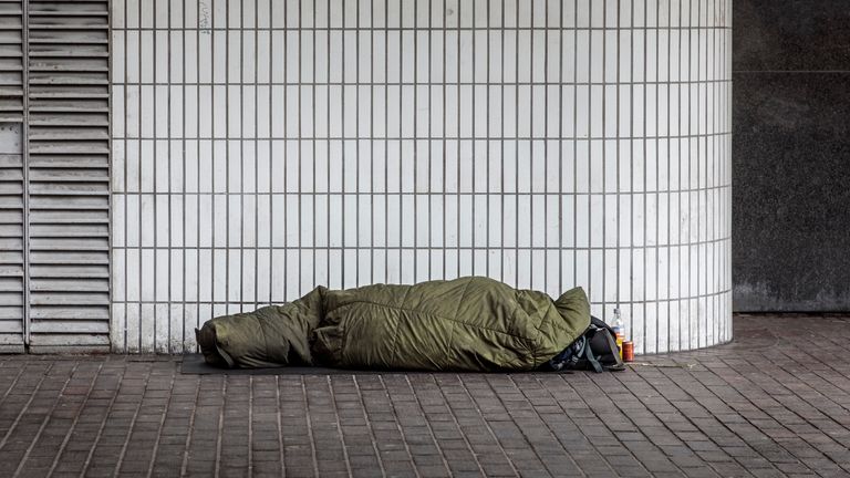 A homeless man in a sleeping bag outside Euston Station