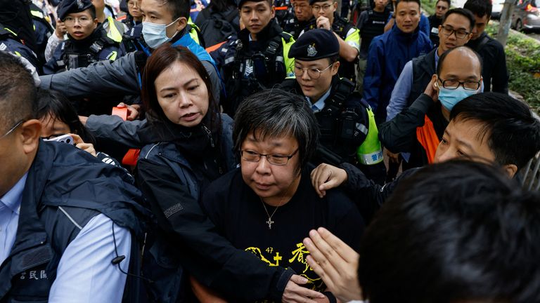 A woman is taken away by police outside the court Pic: Reuters