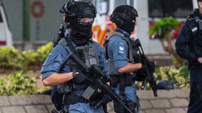 Armed police stand guard outside the West Kowloon Magistrates' Courts in Hong Kong. Pic: AP Photo/Chan Long Hei