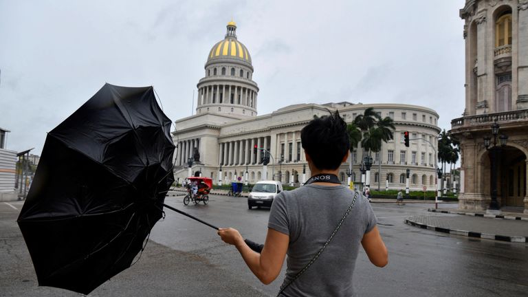 Hurricane Rafael lashes Cuba. A tourer  from China tries to clasp  his umbrella arsenic  Hurricane Rafael passes by Havana, Cuba, November 6, 2024. REUTERS/Norlys Perez