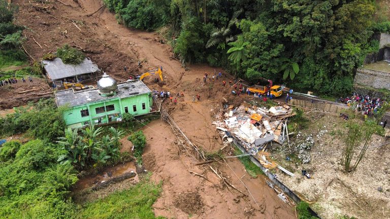 Rescuers search for victims after a landslide that killed a number of people and left some others missing in Karo, North Sumatra, Indonesia.
Pic: AP