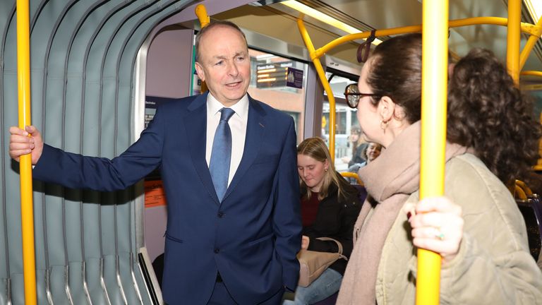 Fianna Fail leader Micheal Martin speaks to a member of the public while campaigning on board the Luas in Dublin on the day the election was confirmed.
Pic: PA