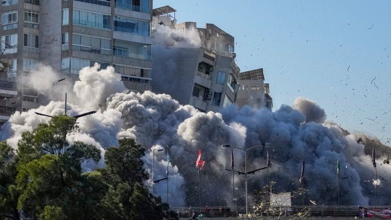 Smoke covers a building that collapses following an Israeli airstrike in Tayouneh, Beirut, Lebanon, Friday, Nov. 15, 2024. (AP Photo/Hassan Ammar)