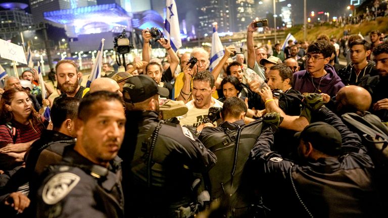 Israeli police try to push back protesters from a main road.
Pic: AP