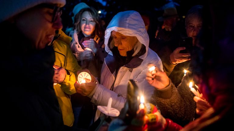 Rosalis Estes, center, at a vigil for No. 399 in Jackson. Pic: AP 