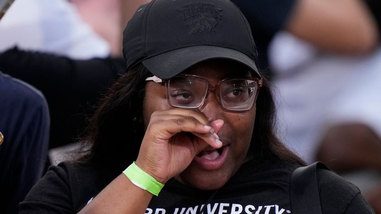 An attendee wipes away tears after Vice President Kamala Harris delivers a concession speech for the 2024 presidential election on the campus of Howard University in Washington, Wednesday, Nov. 6, 2024. (AP Photo/Ben Curtis)