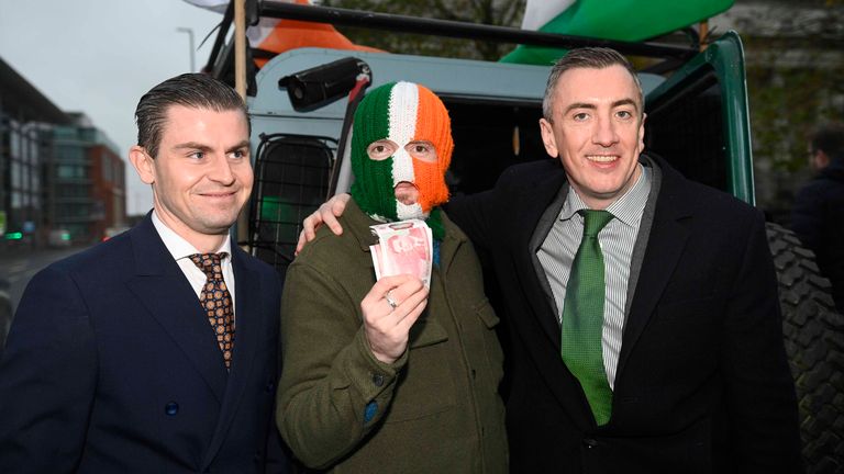 JJ O'Dochartaigh, also known as DJ Provai, of the Belfast-based rap group Kneecap, outside Belfast High Court, with lawyers Darragh Mackin (left) and Gavin Booth (right), after the Irish language rap-trio won its legal challenge over a decision by former business secretary Kemi Badenoch to refuse them a £14,250 funding award after the UK Government conceded at Belfast High Court it was "unlawful". Picture date: Friday November 29, 2024.