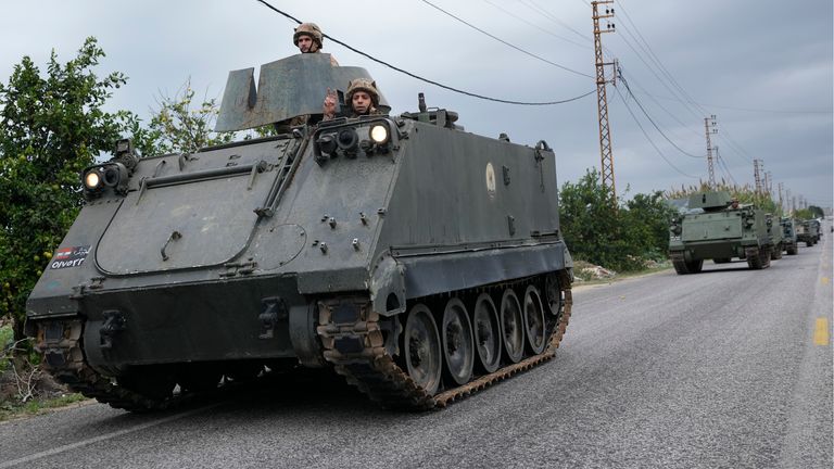 Lebanese soldiers ride in a convoy in Mansouri, as they head to southern Lebanon, following a ceasefire between Israel and Hezbollah that went into effect on Wednesday, Nov. 27, 2024. (AP Photo/Hussein Malla)