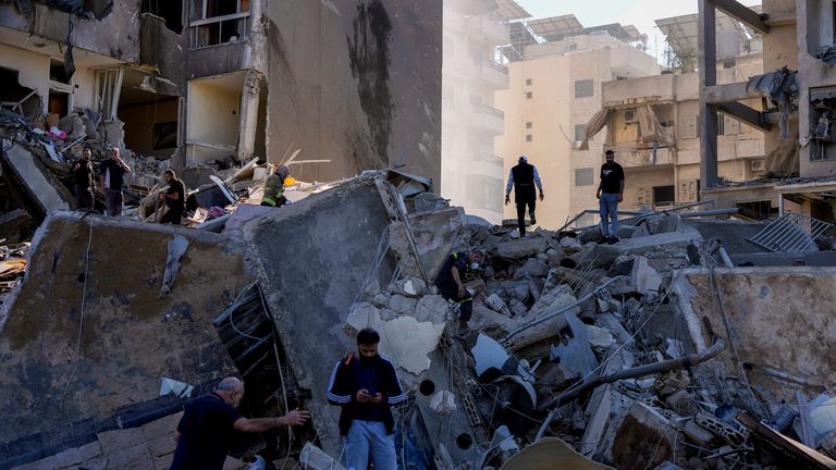 Residents check the site of an Israeli airstrike in Tayouneh, Beirut, Lebanon, Friday, Nov. 15, 2024. (AP Photo/Hassan Ammar)