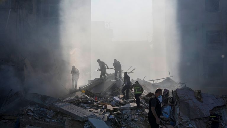 Civil defense workers extinguish a fire as smoke rises from the site of an Israeli airstrike in Tayouneh, Beirut, Lebanon, Friday, Nov. 15, 2024. (AP Photo/Hassan Ammar)