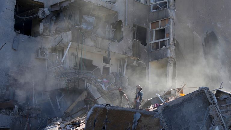 Residents check the site of an Israeli airstrike in Tayouneh, Beirut, Lebanon, Friday, Nov. 15, 2024. (AP Photo/Hassan Ammar)