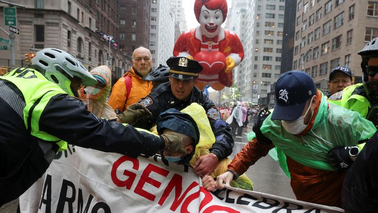 Police officers detain a protester during the 98th Macy's Thanksgiving Day Parade in New York City, U.S., November 28, 2024. REUTERS/Brendan McDermid

