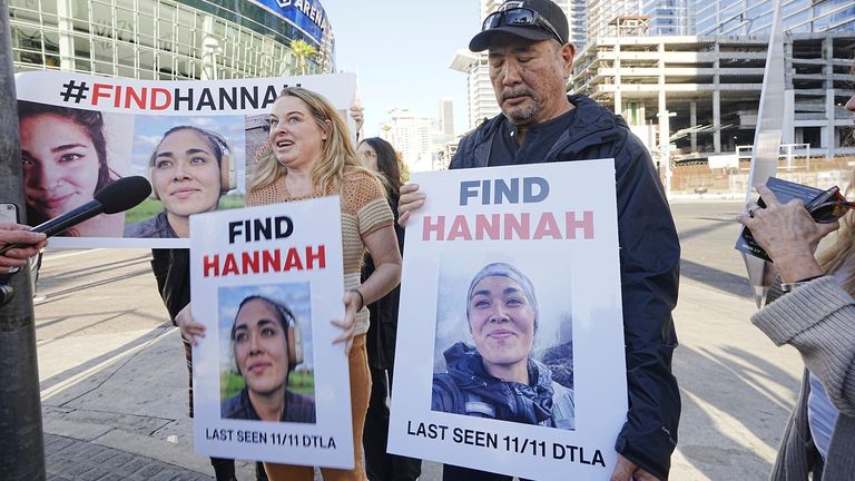 Ryan Kobayashi (centre right) holds a poster for his missing daughter.
Pic: AP