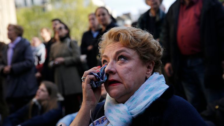 A woman cries as she attends the Chrism Mass, as part of the Holy Week, at the Saint Sulpice Church in Paris, Wednesday, April 17, 2019. The mass took place days after a fire partially destroyed the Notre Dame Cathedral in the early evening of April 15. (AP Photo/Christophe Ena)