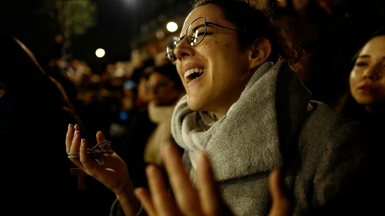 A woman reacts as she attends a vigil in Paris, Tuesday April 16, 2019. Firefighters declared success Tuesday in a more than 12-hour battle to extinguish an inferno engulfing Paris' iconic Notre Dame cathedral that claimed its spire and roof, but spared its bell towers and the purported Crown of Christ. (AP Photo/Kamil Zihnioglu)