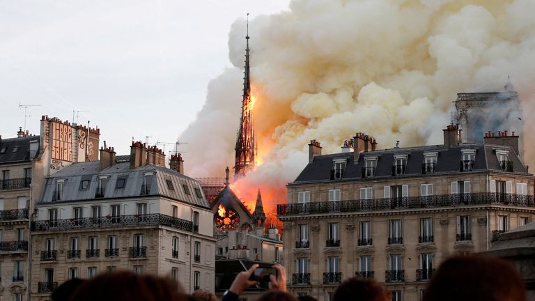 FILE PHOTO: Smoke billows as fire engulfs the spire of Notre Dame Cathedral in Paris, France, April 15, 2019. Picture taken April 15, 2019. REUTERS/Benoit Tessier/File Photo

