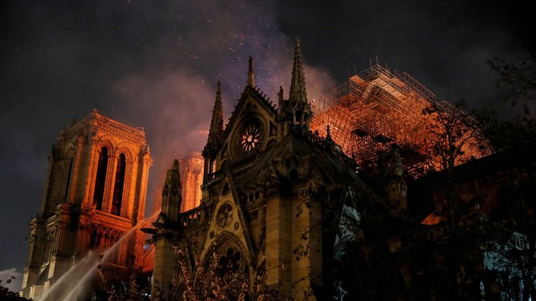 FILE PHOTO: Sparks fill the air as Paris Fire brigade members spray water to extinguish flames as the Notre Dame Cathedral burns in Paris, France, April 15, 2019. REUTERS/Philippe Wojazer/File Photo

