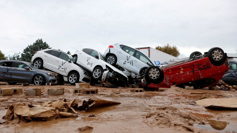 Vehicles marked by firefighters, with a code indicating that they have searched for casualties from the floods in Paiporta. Pic: Reuters