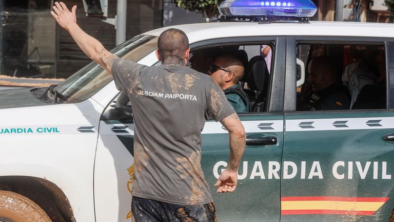 A man talks to a Guardia Civil officer on November 1, 2024, in Paiporta, Valencia, Valencia (Spain). The sixth death toll from the passage of the DANA through the province of Valencia leaves 202 fatalities. Since late on Tuesday, the Multiple Victims Procedure has been activated, which is carrying out the balances provided through the information received from the different security and emergency bodies and forces. In addition, the material damage is uncountable, with roads cut off and areas isolated by water, mud and landslides. Approximately 23,000 people are still without electricity supply in the province of Valencia because of the storm of the DANA, after having recovered more than 132,000 affected since Wednesday, 85 percent of those initially damaged. This DANA is the most tragic atmospheric catastrophe that has been registered in Spain in more than half a century. 01 NOVEMBER 2024 Rober Solsona / Europa Press 11/01/2024 (Europa Press via AP)