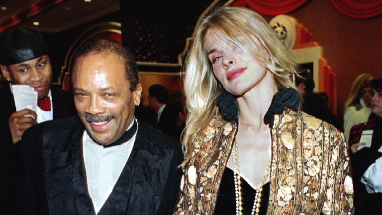 Quincy Jones and Nastassja Kinski shake hands with a fan on December 31 (BM add - 1993)