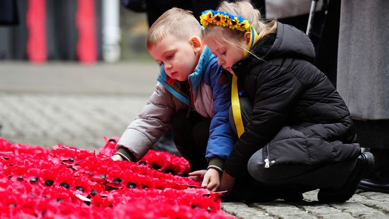 Young Ukrainian residents in Edinburgh lay their wreaths outside the City Chambers. Pic: PA