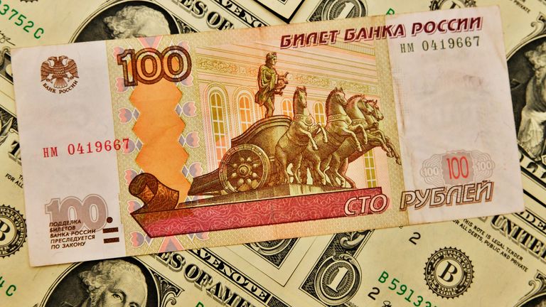 'Panic' in Russia as rouble slips to symbolic mark against US dollar ...