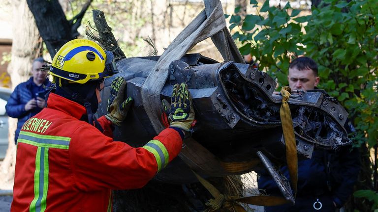 Emergency services remove part of a Russian missile from an apartment building in Kyiv. Pic: Reuters