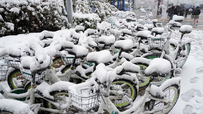 Snow-covered bicycles are parked near a subway station in Seoul. Pic: AP