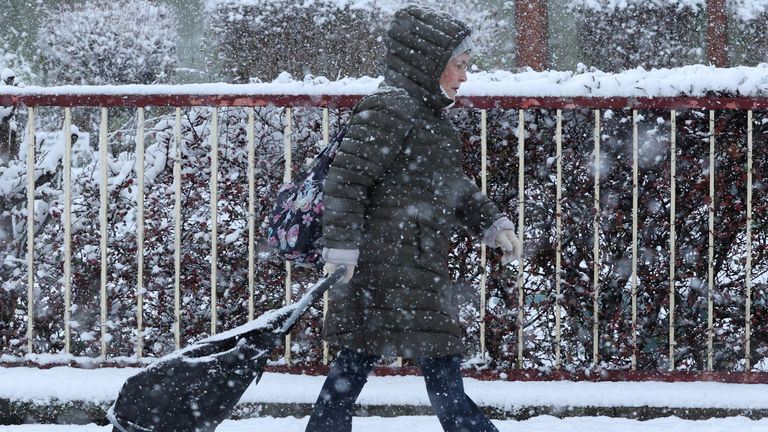 A woman braves the snow in Aviemore, Scotland. Pic: Reuters