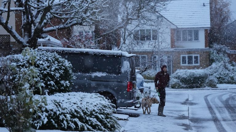 A person walks their dog through snow in Warwick. The UK is bracing for snow, ice and cold temperatures as up to 20cm of snow could hit the UK over the coming days. Picture date: Tuesday November 19, 2024. PA Photo. See PA story WEATHER Snow. Photo credit should read: Jacob King/PA Wire