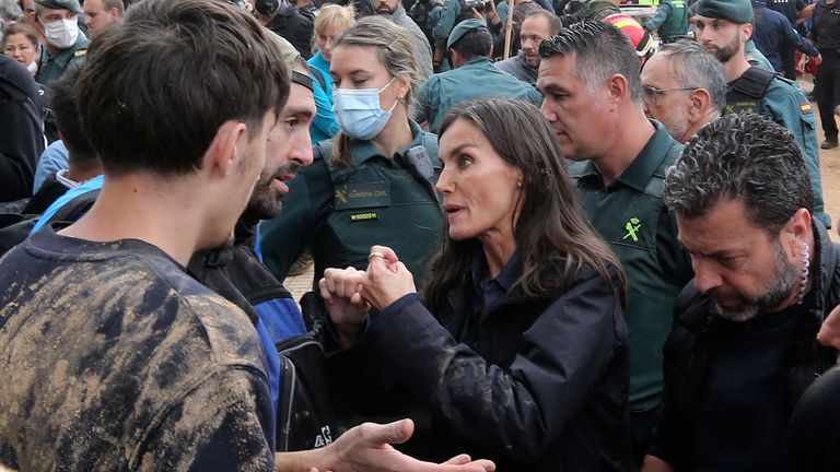 Spain's Queen Letizia speaks with people affected by the floods after crowd of angry survivors of Spain's floods tossed mud and shouted insults at the Spain's King Felipe and government officials when they made their first visit to one of the hardest hit towns. after floods in Paiporta near Valencia, Spain, Sunday, Nov. 3, 2024. (AP Photo/Hugo Torres)