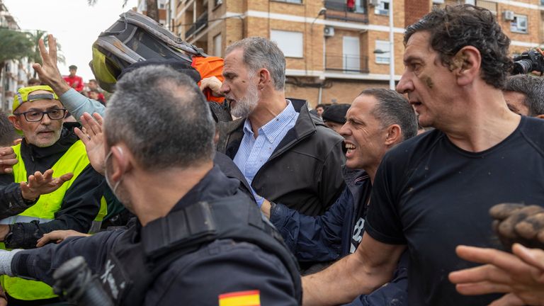 Spain's King Felipe VI, centre, walks amidst angry Spanish flood survivors in Paiporta, near Valencia, Spain, Sunday Nov. 3, 2024. (AP Photo/David Melero)