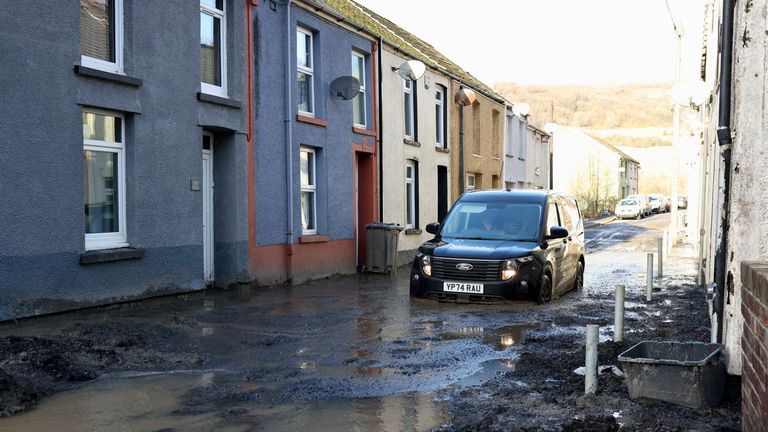 A car drives through mud at the site of a mudslide, in the aftermath of Storm Bert, in Cwmtillery, South Wales, Britain, November 25, 2024. REUTERS/Hollie Adams
