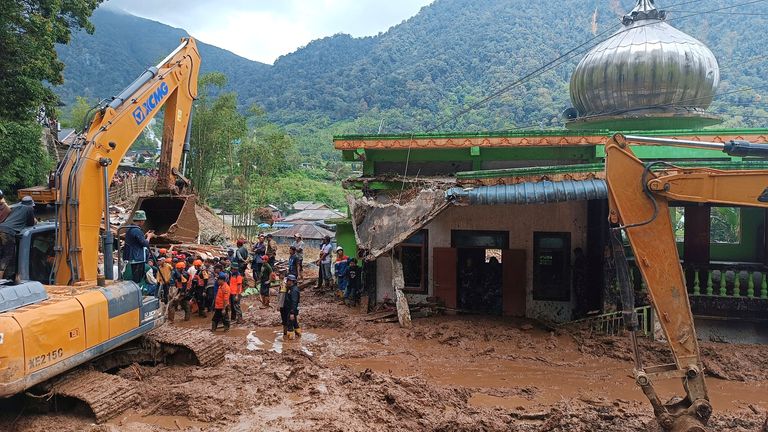 Rescuers search for victims after a landslide that killed a number of people and left some others missing in Karo, North Sumatra, Indonesia.
Pic: AP