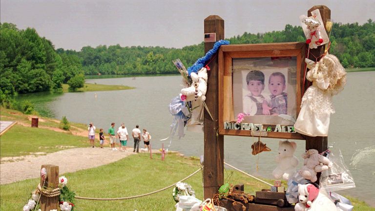 FILE - In a July 9, 1995 file photo, visitors walk down the ramp where Alex and Michael Smith were drowned in a car in 1994 in Union, S.C., by their mother, Susan Smith. (AP Photo/Lou Krasky, File)