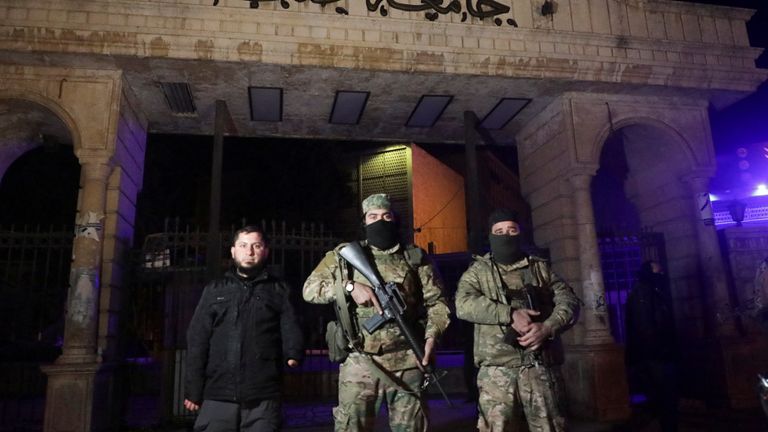 Syrian opposition fighters stand in front of University of Aleppo, after rebels opposed to Syria's President Bashar al-Assad said they had reached the heart of Aleppo, Syria November 30, 2024. REUTERS/Mahmoud Hasano

