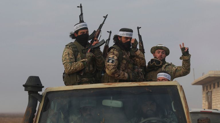 Syrian opposition fighters ride in a truck in Talhiya, Idlib countryside, Syria, Friday, Nov. 29, 2024. (AP Photo/Ghaith Alsayed)