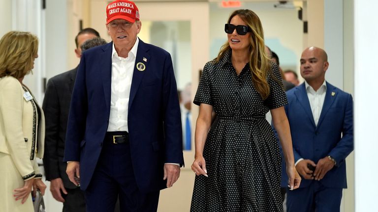 Republican presidential candidate, former President Donald Trump, and former first lady Melania Trump walk after voting on Election Day at the Morton and Barbara Mandel Recreation Center, Tuesday, Nov. 5, 2024, in Palm Beach, Florida. (AP Photo/Evan Vucci)