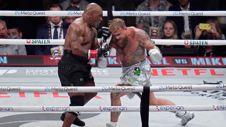 Mike Tyson, left, fights Jake Paul during their heavyweight boxing match, Friday, Nov. 15, 2024, in Arlington, Texas. (AP Photo/Julio Cortez)