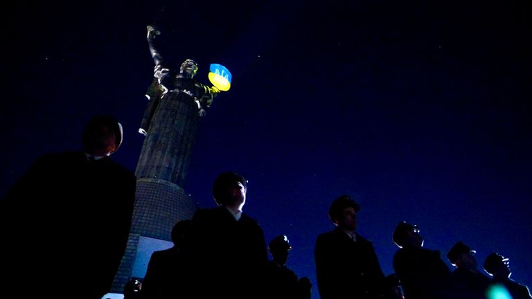 Soldiers stand to attention beneath Ukraine's motherland statue