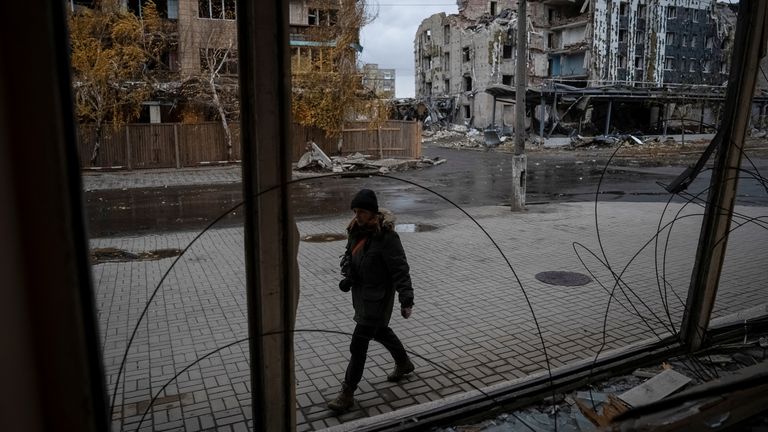 A photographer walks past buildings damaged by a Russian military strike, amid Russia's attack on Ukraine, in the town of Pokrovsk in Donetsk region, Ukraine November 4, 2024. REUTERS/Inna Varenytsia
