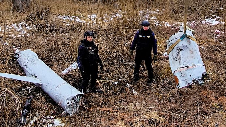 Ukrainian servicemen examine a Russian cruise missile shot down in Kyiv. Pic: Ukrainian Emergency Service/AP