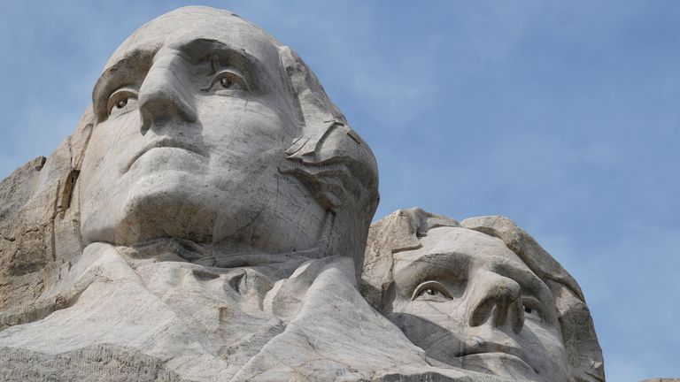 Visitors admire the massive sculpture carved into Mount Rushmore at the Mount Rushmore National Memorial on Thursday, Sept. 21, 2023, in Keystone, SD (AP Photo/David Zalubowski)