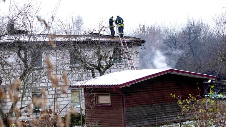 Emergency servoices at the scene where a DHL cargo plane crashed into a house near the Lithuanian capital of Vilnius.
Pic: AP