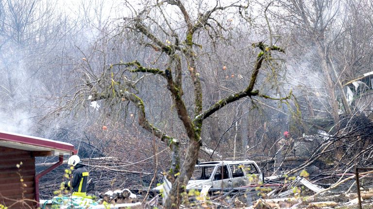 Emergency servoices at the scene where a DHL cargo plane crashed into a house near the Lithuanian capital of  Vilnius.
Pic: AP