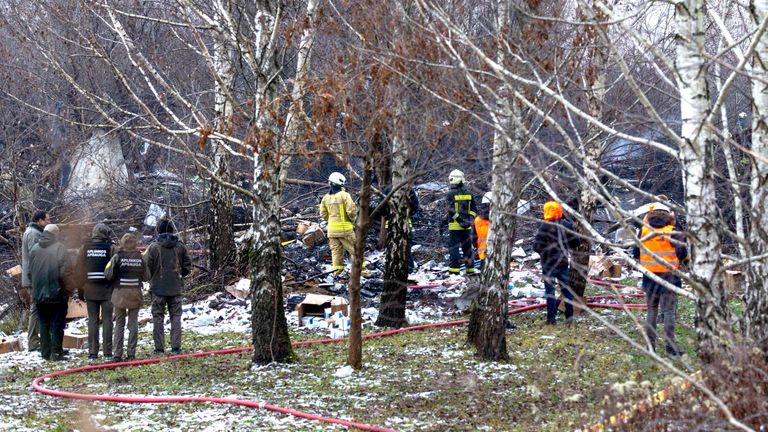 Emergency servoices at the scene where a DHL cargo plane crashed into a house near the Lithuanian capital of Vilnius.
Pic: AP