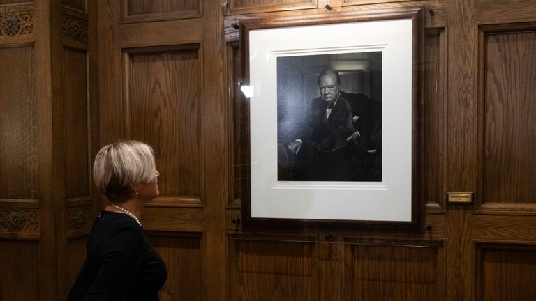 Fairmont Chateau Laurier general manager Genevieve Dumas stands in front of Yousuf Karsh's 1941 portrait of Winston Churchill following its unveiling at the hotel, Friday, Nov. 15, 2024 in Ottawa. (Adrian Wyld/The Canadian Press via AP)