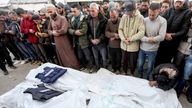 Mourners pray beside the bodies during the funeral of Palestinian journalists from Al-Quds Al-Youm television channel who were killed in Israeli airstrikes, according to medics with the Gaza health authorities, amid the Israel-Hamas conflict, at Al-Aqsa Martyrs Hospital, in Deir Al-Balah, in the central Gaza Strip, December 26, 2024. REUTERS/Ramadan Abed     TPX IMAGES OF THE DAY     
